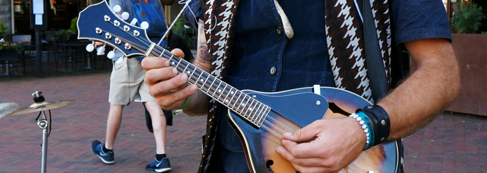 musician playing mandolin outdoors downtown asheville
